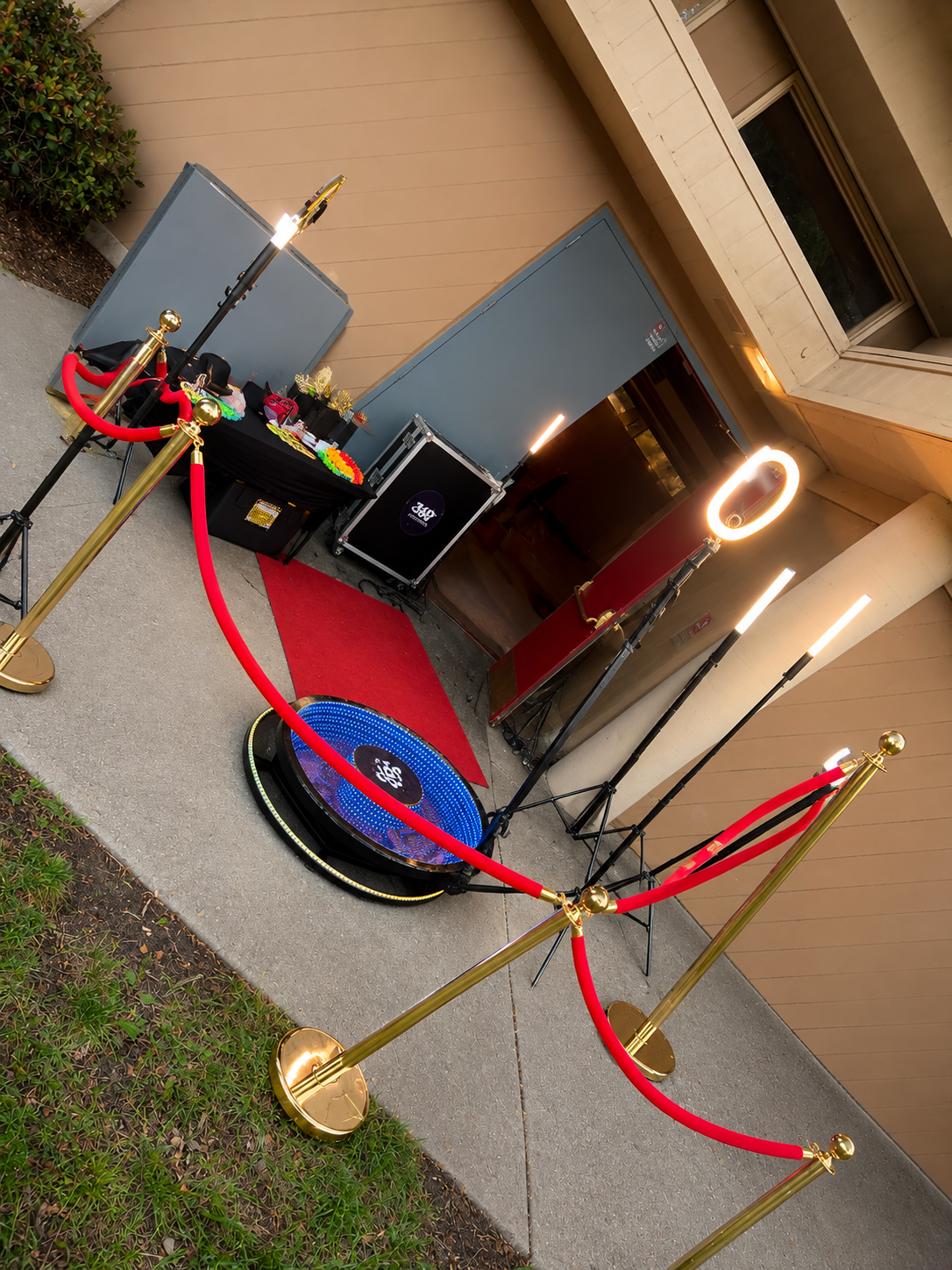 Tapia's DJ 360 Photo Booth with red carpet, velvet ropes, and event lighting